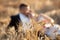 Blurred and unrecognizable married couple kissing in a wheat field