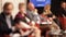 Blurred unrecognizable participants at round table political event or business conference