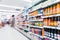 Blurred variety of fruit juice concentrate and Mixed fruit juice on shelves at grocery store supermarket