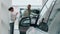 Blurred view african american man buyer talking with seller choosing automobile in dealership showroom woman auto dealer