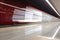 Blurred view of arriving subway train to Kommunarka underground station with wine-coloured walls.