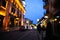 Blurred view of beautiful cityscape with glowing streetlights and illuminated building in evening