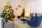 Blurred view of festively decorated room with Christmas tree and furniture