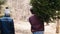 Blurred view of men carrying the christmas tree