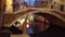 Blurred view of old arched bridge over scenic canal in Venice, Italy