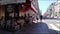 Blurred view of old town with numerous cafes and restaurants. People chat, eat and drink while sitting at cafe.
