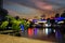 Blurred view of restaurants along a river with a focused branche in the foreground