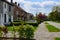 Blurred view of suburban street with beautiful houses and green shrubbery