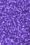 Blurred violet decorative sequins. Background image with shiny bokeh lights from small elements