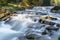 Blurred water and waterfall on a river.