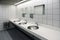 Blurred white washbasins and shiny faucets in toilet with flare