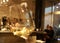 Blurred white wine glass and drinking, resting, talking people in luxury bar or restaurant on background