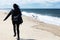 A blurred woman chasing gulls on cape cod beach