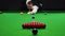 Blurred young man in white shirt playing billiards, snooker game, focusing on shot with cue stick. Concentration and