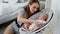 Blurred young woman looking at a cute little baby sleep in bed at home