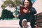 Blurred young woman sits on bench in park with notebook and pen. Wish Marathon.