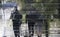 Blurry abstract reflection silhouette of three people walking on a wet city street on a rainy day