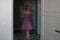 On a blurry background in motion, the indistinct silhouette of a dancing girl in a purple dress