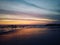 Blurry beach landscape background. Colorful sunset sunrise backgrounds. Dramatic sky colors over horizon. Blurry wave motion.