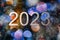 blurry bokey christmas lights 2023 sign