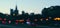 Blurry cityscape silhouette of a European city as background, evening view