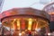 A blurry colorful carousel in motion at the amusement park, evening illumination. The effect of bokeh and long exposure