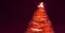 Blurry creative lighted christmas tree banner in red orange palette on a dark background. Xmas and New Year greeting card concept