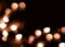 Blurry garland lights on a dark background. Festive Christmas and New Year background. Soft focus. Image toned in color