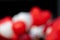 Blurry Group of Red and white Heart balloons blur isolated on black background.