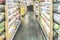 Blurry image interior of shopping mall shelves with nobody in perspective view of central aisle