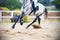 A blurry image of the legs of a spotted gray horse galloping across a sandy arena