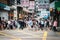 Blurry image of unrecognizable people crossing street in Hong Kong