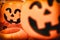 A blurry Jack o`lantern or halloween pumpkins with antique old film camera effect