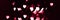 Blurry lights on a dark background. Festive bokeh background in the form of hearts for Valentine's Day. Soft focus