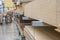 A blurry modern warehouse with building wood materials on metal shelves. Selective focus. Repair and construction concept