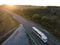 Blurry motion White Truck with Cargo Semi Trailer Moving on Summer Road. Aerial Top View