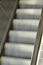 Blurry moving metallic escalator in a shopping mall, airport, metro, train station or other building. Perspective, going up or