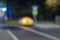 Blurry night street, taxi standing at  traffic lights, defocused city background