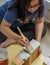 Blurry photo of a girl painting boxes in white colour. Upcycle, recycle and home makeover project