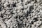 a blurry photo of the zoomed texture of the gray soil of the earth as a background. defocused.