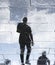 Blurry reflection shadow silhouettes of a man walking on a rainy