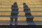 Blurry shadow, silhouette of two people standing next to outdoor steps