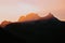 Blurry skyline of mountains with dense forests under the sunset glow