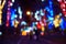 Blurry street lights and festive garlands on the street at night
