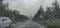 Blurry view of countryside road bad weather.