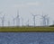 Blurry windmills and sheep in a typical scene at the German North Sea coast