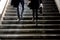 Blurry young man and woman going down the subway stairs