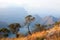 Blyde River Canyon, three green trees, blue lake and mountains in the clouds in sunset light background, South Africa