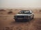 BMW in the desert. The image features a BMW car, covered in dust and dirt, parked in the middle of a vast desert landscape