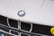 BMW logo brand text and logo sign on old timer vintage retro front car hood face
